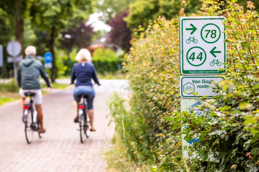 Photo of cyclists and cycle route markers