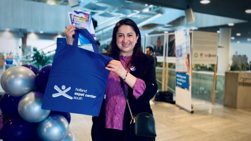 Woman holding a welcome bag and helpful brochures