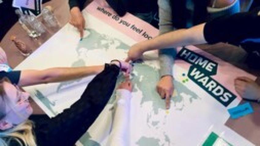 People's arms pointing to locations on a map