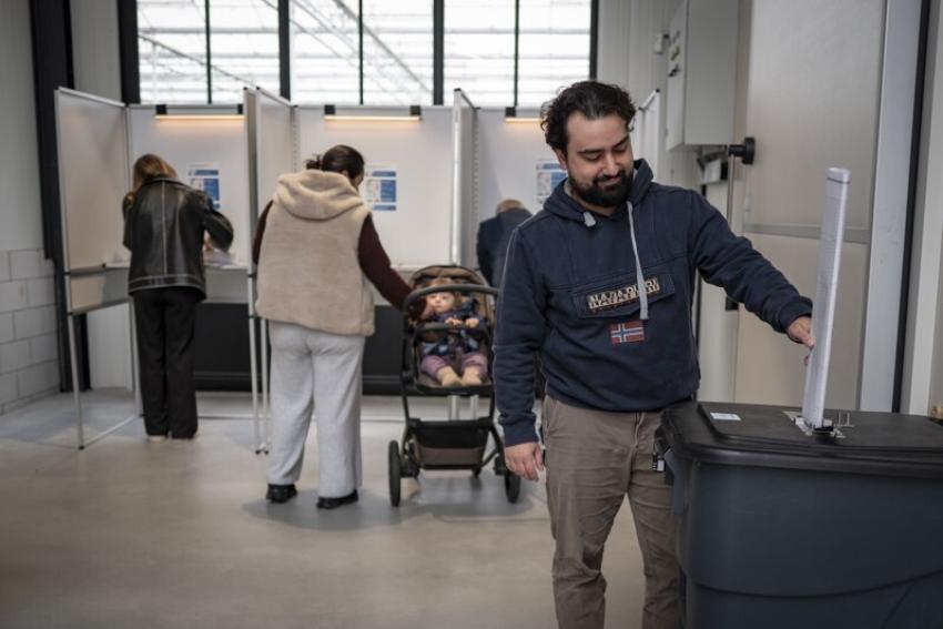 Voting booths and people voting