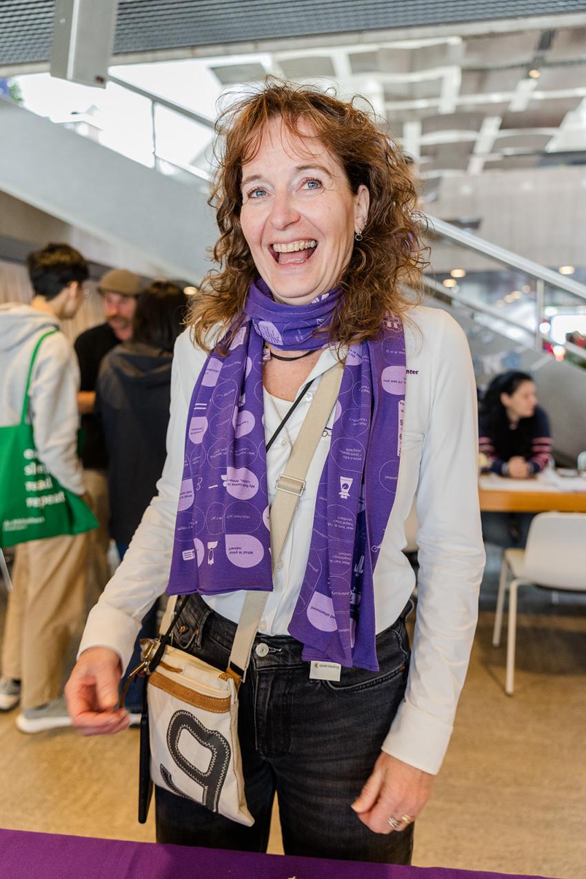 A woman wearing a purple cheat-sheet scarf