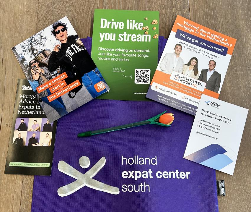 Welcome bag with flyers from Commercial Partners in housing, insurance and transport 