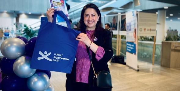 Woman holding a welcome bag and helpful brochures