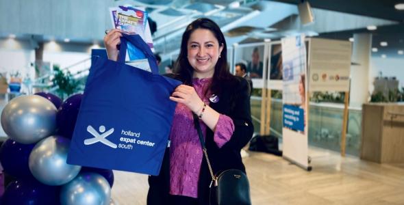 Woman holding a welcome bag and helpful brochures