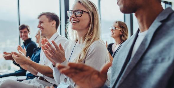 Photo of people clapping at a presentation