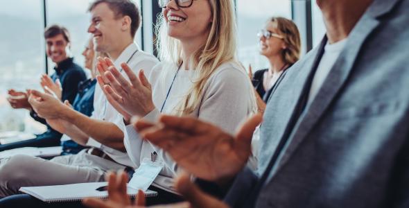 Photo of people clapping at a presentation
