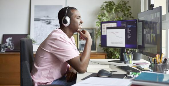 Man with headphones working in a home office