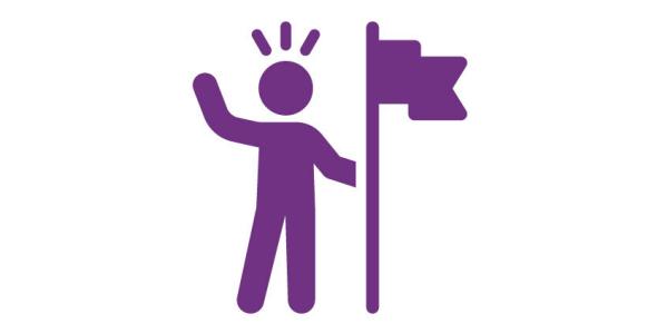 A person speaking out and holding a flag
