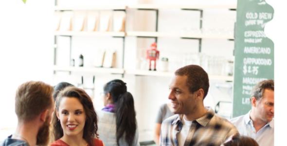 People smiling and talking at an event