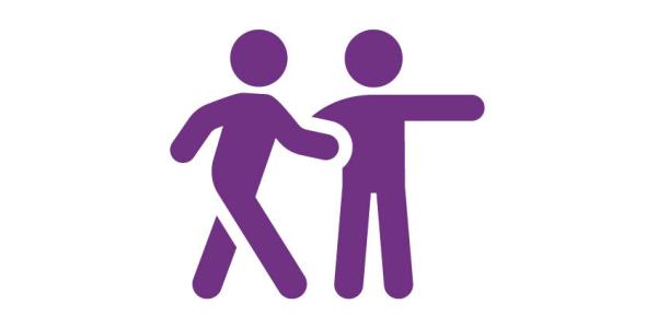 Two people, with one showing the other one the way