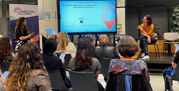 Audience and speaker viewing a presentation
