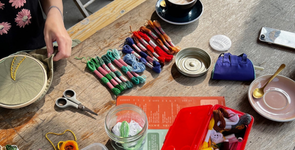 Table with mending materials such as scissors, cotton and thread