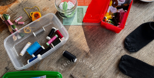 Table with mending materials such as scissors, cotton and thread