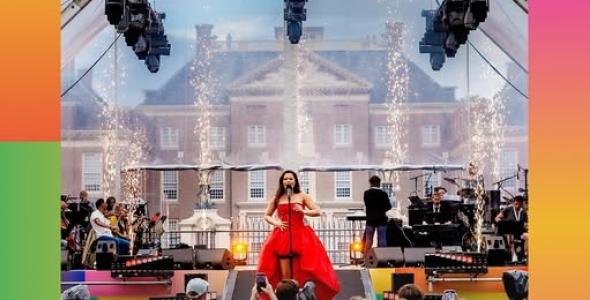 Woman in a red dress singing on stage